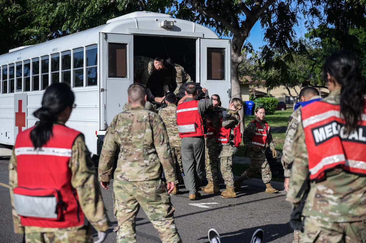 Airmen assigned to the 15th Medical Group transport volunteers with simulated injuries onto a medical bus during a Joint Base Readiness Exercise at Joint Base Pearl Harbor-Hickam, Hawaii, Mar. 8, 2023. The 15th Wing’s ability to surge combat-ready forces across the theater is critical to supporting regional alliances, partnerships and stability. (U.S. Air Force photo by Staff Sgt. Alan Ricker)