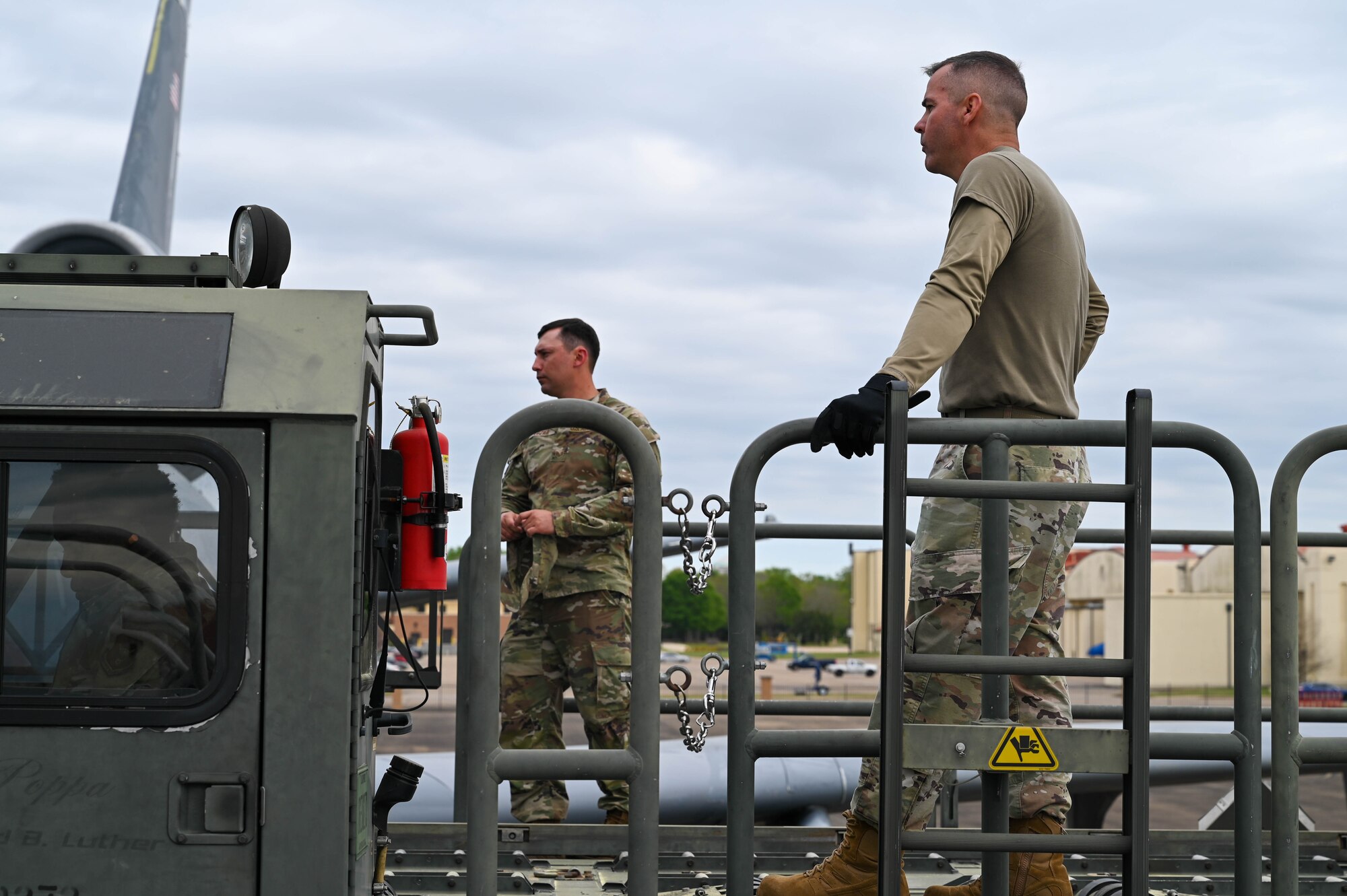 two men load cargo on an aircraft