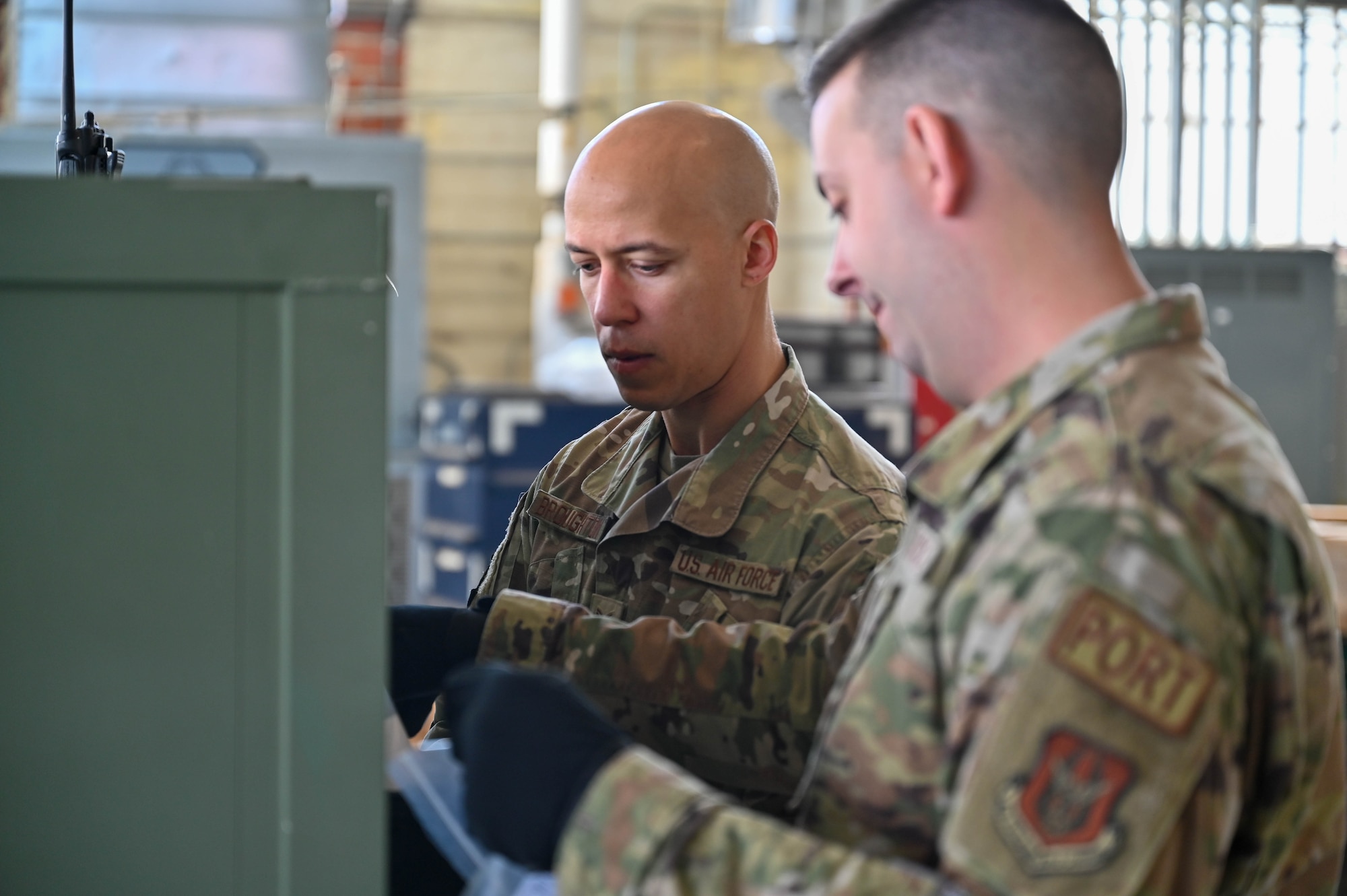 two men prepare cargo for transport