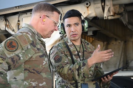 Master Sgt. Jovani Montenegro, 433rd Maintenance Group quality assurance inspector, speaks to Brig. Gen. Max Stitzer, mobilization assistant to Headquarters Air Force Director of Staff, about the process of a quality verification inspection on a thru-flight inspection during a tour visit at Joint Base San Antonio-Lackland, Texas, March 5, 2023.