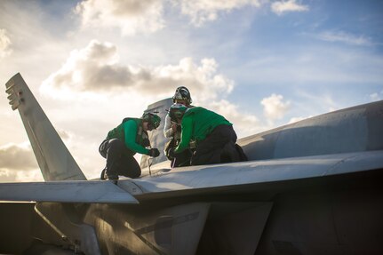 Sailors maintain an F/A-18E Super Hornet aboard USS Gerald R. Ford (CVN 78).