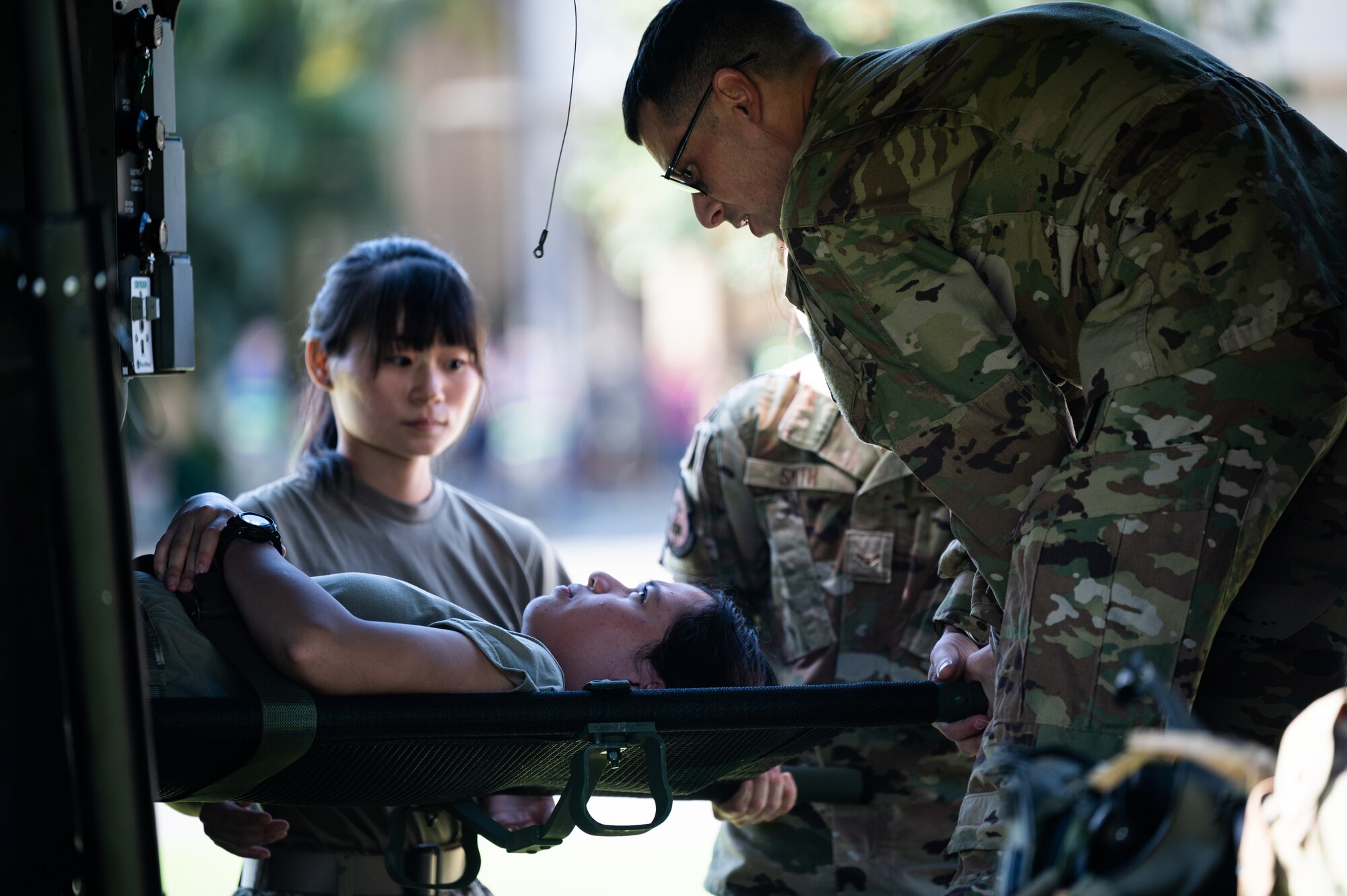 Airmen assigned to the 15th Medical Group and soldiers from the 25th Combat Aviation Brigade practice patient litter carries to and from an HH-60 Black Hawk during a Joint Base Readiness Exercise at Joint Base Pearl Harbor-Hickam, Hawaii, Mar. 8, 2023. The 15th Wing trains to operate, fight and advance its capabilities through realistic training exercises designed to test and develop joint logistics, resilience and rapid strategic mobility. (U.S. Air Force photo by Staff Sgt. Alan Ricker)