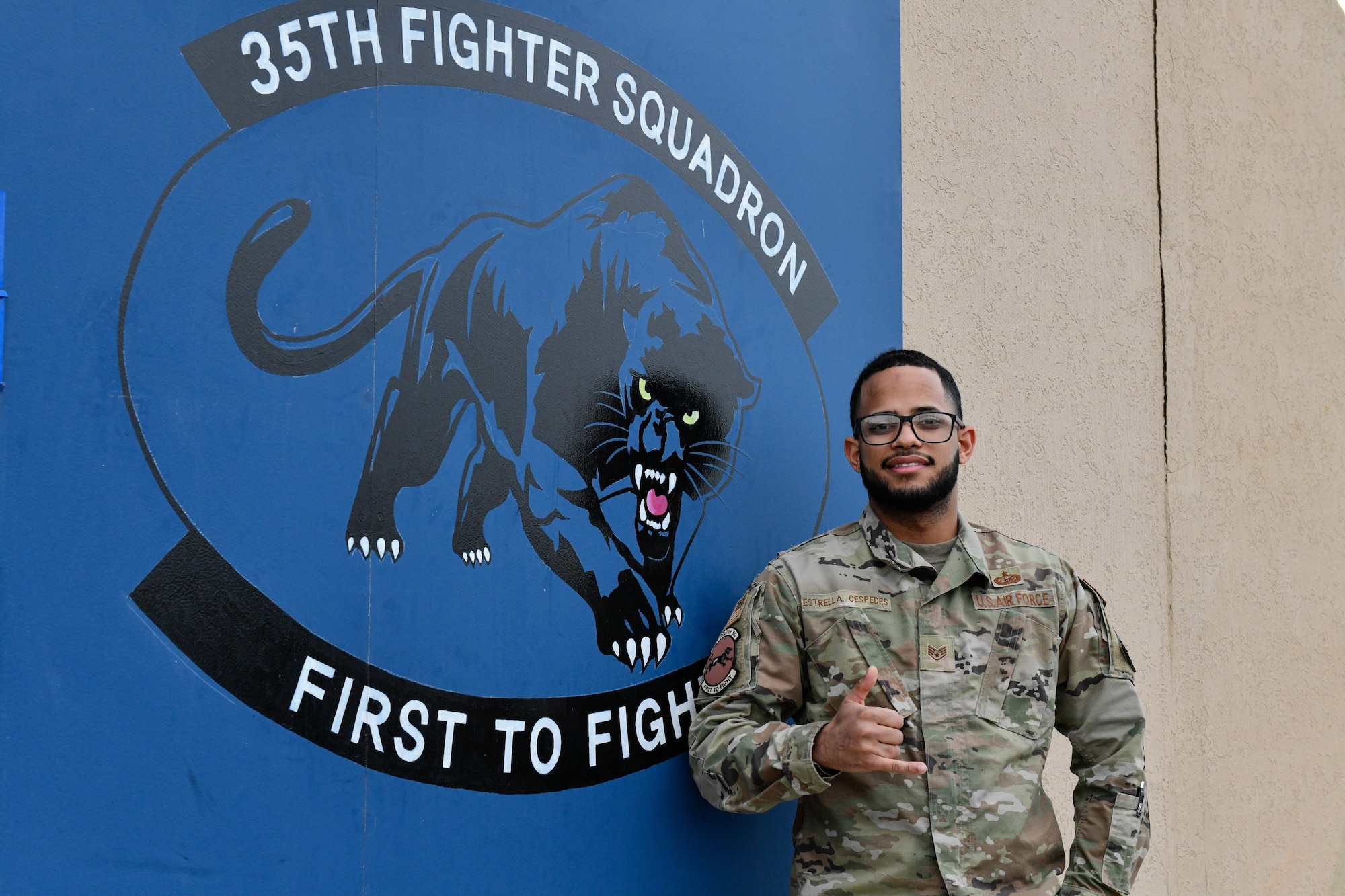 man stands in front of panther logo