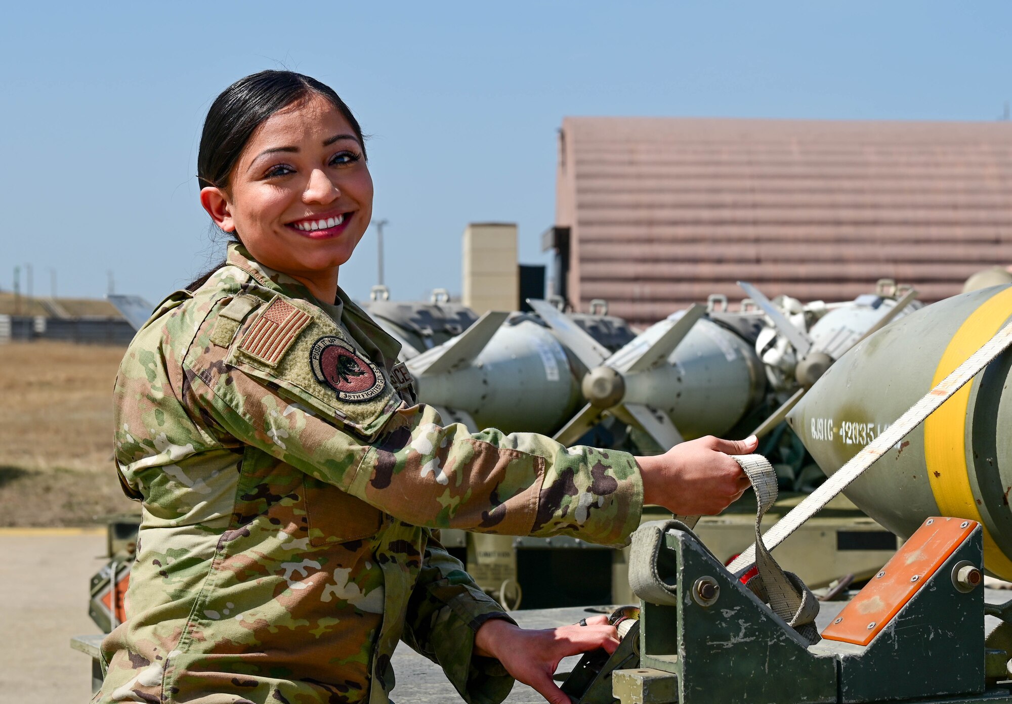 Airman 1st Class Katelyn Chavez, 8th Maintenance Squadron weapons load team member, tightens a munition strap at Kunsan Air Base, Republic of Korea, Mar. 21, 2023.