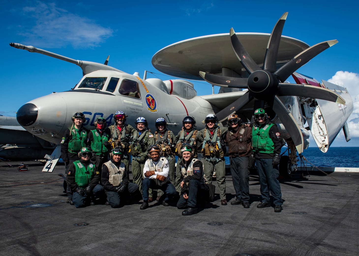 (March 17, 2023) Cmdr. Robert Whitmore, commander, Airborne Command and Control Squadron (VAW) 12,1 pose for a group photo with his team before a change of command ceremony aboard the Nimitz-class aircraft carrier USS George H.W. Bush (CVN 77), March 17, 2023. During the ceremony Cmdr. Matthew Campbell relieved Whitmore as commander, VAW-121. Carrier Air Wing (CVW) 7 is the offensive air and strike component of Carrier Strike Group (CSG) 10 and the George H.W. Bush CSG. The squadrons of CVW-7 are Strike Fighter Squadron (VFA) 143, VFA-103, VFA-86, VFA-136, VAW-121, Electronic Attack Squadron (VAQ) 140, Helicopter Sea Combat Squadron (HSC) 5, and Helicopter Maritime Strike Squadron (HSM) 46. The George H.W. Bush CSG is on a scheduled deployment in the U.S. Naval Forces Europe area of operations, employed by U.S. Sixth Fleet to defend U.S., allied and partner interests.