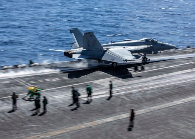 (March 17, 2023) An F/A-18E Super Hornet aircraft, attached to Strike Fighter Squadron (VFA) 136, takes off from the flight deck of the Nimitz-class aircraft carrier USS George H.W. Bush (CVN 77) during flight operations, March 17, 2023. Carrier Air Wing (CVW) 7 is the offensive air and strike component of Carrier Strike Group (CSG) 10 and the George H.W. Bush CSG. The squadrons of CVW-7 are VFA-143, VFA-103, VFA-86, VFA-136, Carrier Airborne Early Warning Squadron (VAW) 121, Electronic Attack Squadron (VAQ) 140, Helicopter Sea Combat Squadron (HSC) 5, and Helicopter Maritime Strike Squadron (HSM) 46. The George H.W. Bush CSG is on a scheduled deployment in the U.S. Naval Forces Europe area of operations, employed by U.S. Sixth Fleet to defend U.S., allied, and partner interests.