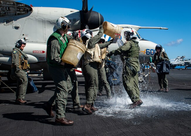 (March 17, 2023) Sailors assigned to Airborne Command and Control Squadron (VAW) 121 splash Cmdr. Robert Whitmore, commander, VAW-121, after a change of command ceremony, March 8, 2023. During the ceremony Cmdr. Matthew Campbell relieved Cmdr. Robert Whitmore as commander, VAW-121. Carrier Air Wing (CVW) 7 is the offensive air and strike component of Carrier Strike Group (CSG) 10 and the George H.W. Bush CSG. The squadrons of CVW-7 are Strike Fighter Squadron (VFA) 143, VFA-103, VFA-86, VFA-136, Electronic Attack Squadron (VAQ) 140, VAW-121, Helicopter Sea Combat Squadron (HSC) 5, and Helicopter Maritime Strike Squadron (HSM) 46. The George H.W. Bush CSG is on a scheduled deployment in the U.S. Naval Forces Europe area of operations, employed by U.S. Sixth Fleet to defend U.S., allied and partner interests.