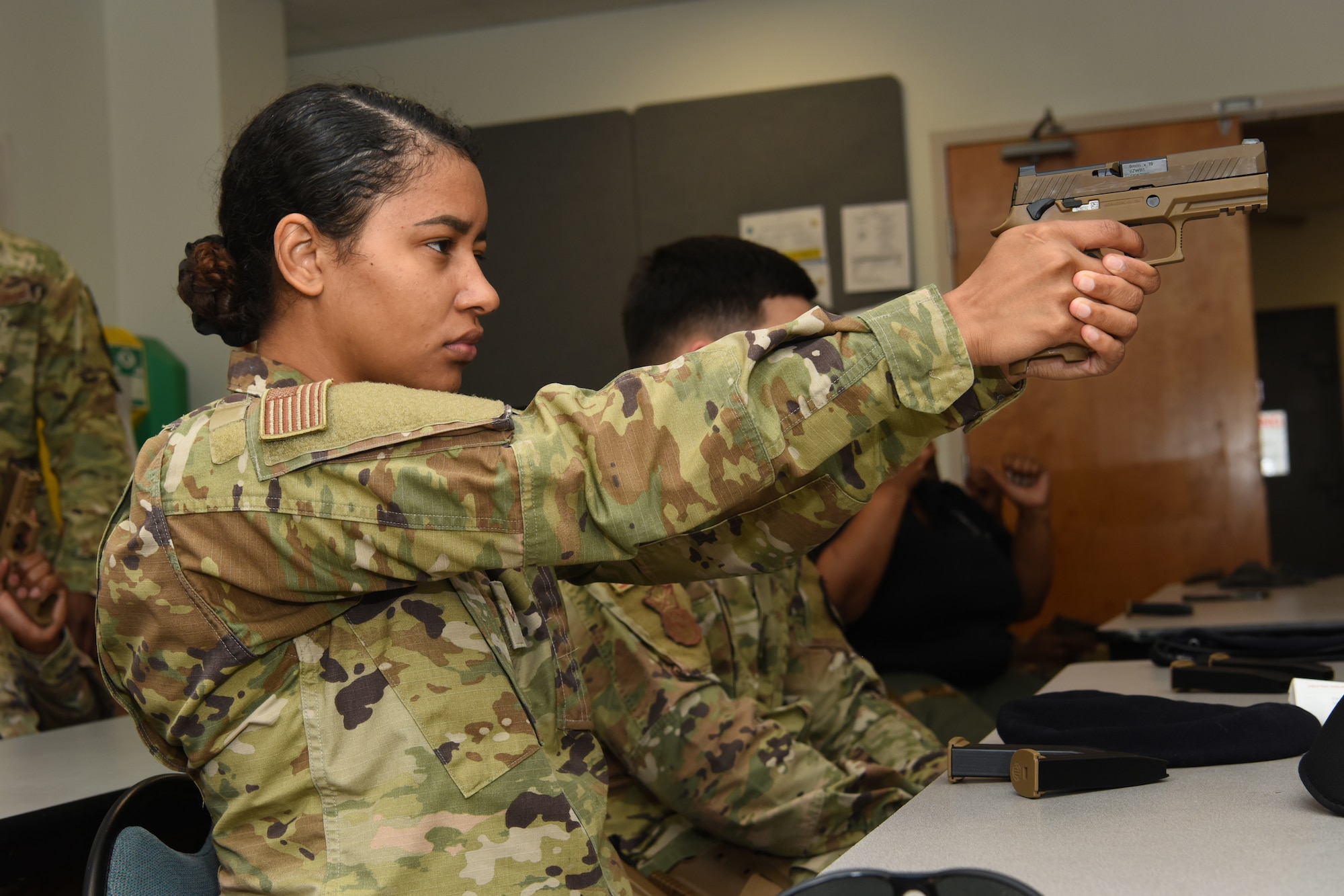 U.S. Air Force Airmen assigned to the 169th Security Forces Squadron engage in a safety brief for the M-18 pistol at McEntire Joint National Guard Base, South Carolina Air National Guard, March 7, 2023. The training equips Airmen with the necessary skills to operate a weapon efficiently in combative scenarios. (U.S. Air National Guard photo by Airman 1st Class Danielle Dawson)