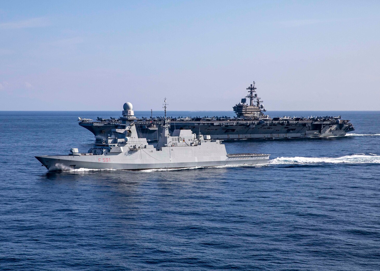 (March 5, 2023) The Carlo Bergamini-class frigate ITS Virginio Fasan (F 591) and the Nimitz-class aircraft carrier USS George H.W. Bush (CVN 77) transit the Mediterranean Sea, March 5, 2023. The George H.W. Bush CSG is on a scheduled deployment in the U.S. Naval Forces Europe area of operations, employed by U.S. Sixth Fleet to defend U.S., allied and partner interests.