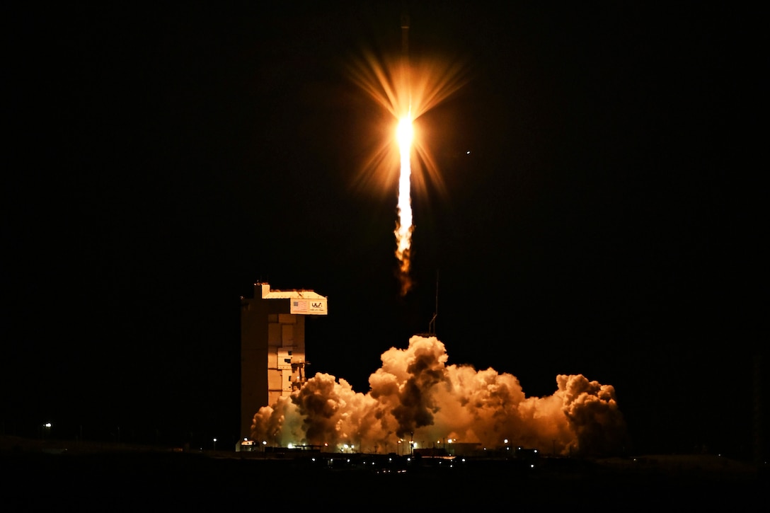 A rocket launches against a dark sky.