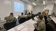 MAJ Thomas A. Lenz, 3rd MSG Executive Officer, briefs the brigade staff on the Military Decision Making Process at the Mission Training Complex, JBER, AK.