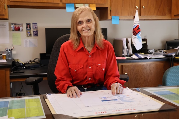 Lady sitting at desk.