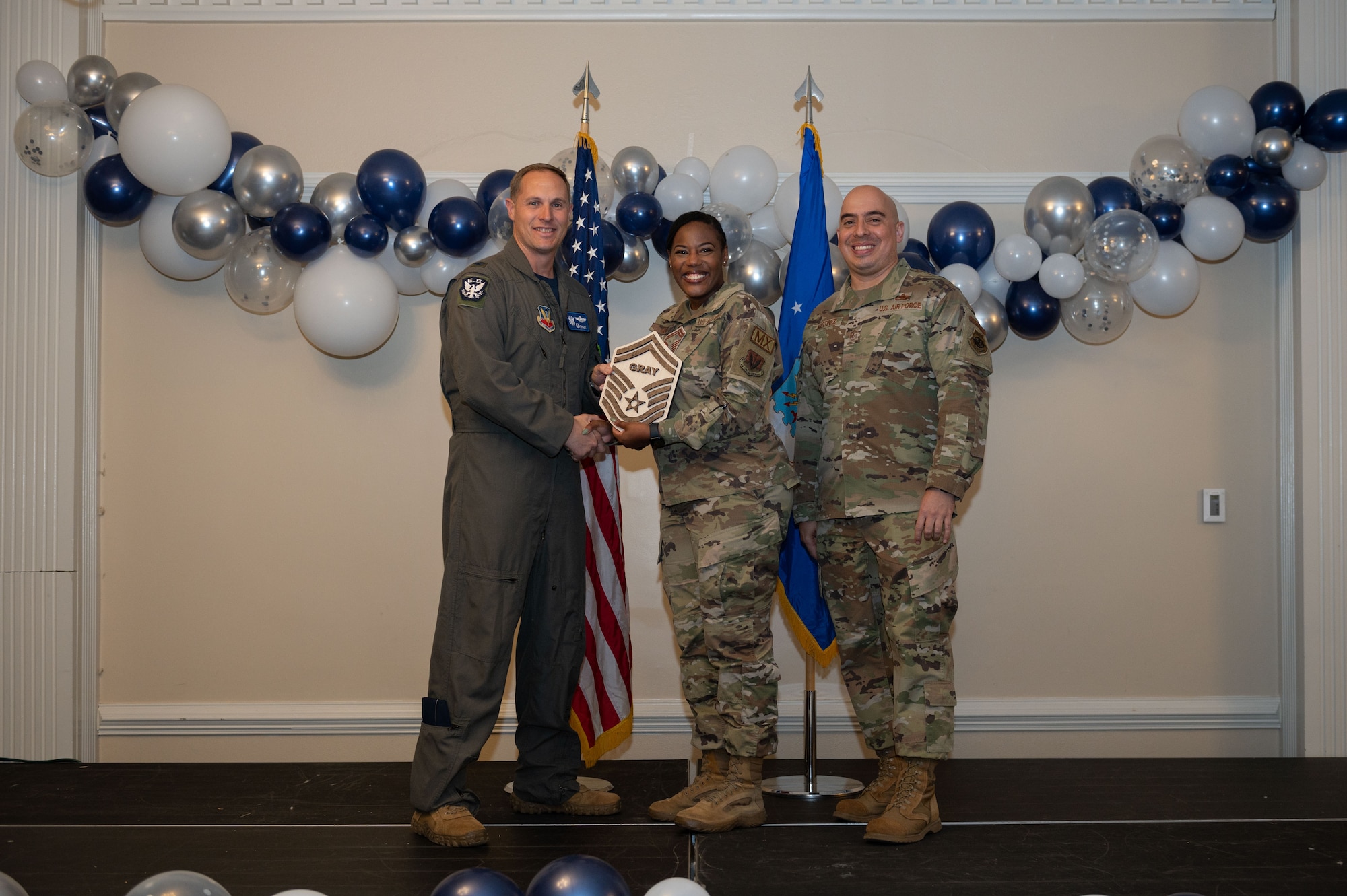 Col. Lucas Teel, 4th Fighter Wing commander, and Chief Master Sgt. Peter Martinez, 4th FW command chief, present a plaque to Senior Master Sgt. select Johnetta Gray, 4th Equipment Maintenance Squadron maintenance flight chief, during the senior master sergeant release ceremony at Seymour Johnson Air Force Base, North Carolina, March 17, 2023. The ceremony allowed wing leadership, family and friends to recognize the base’s newest Senior Master Sergeant selects. (U.S. Air Force photo by Airman 1st Class Rebecca Sirimarco-Lang)