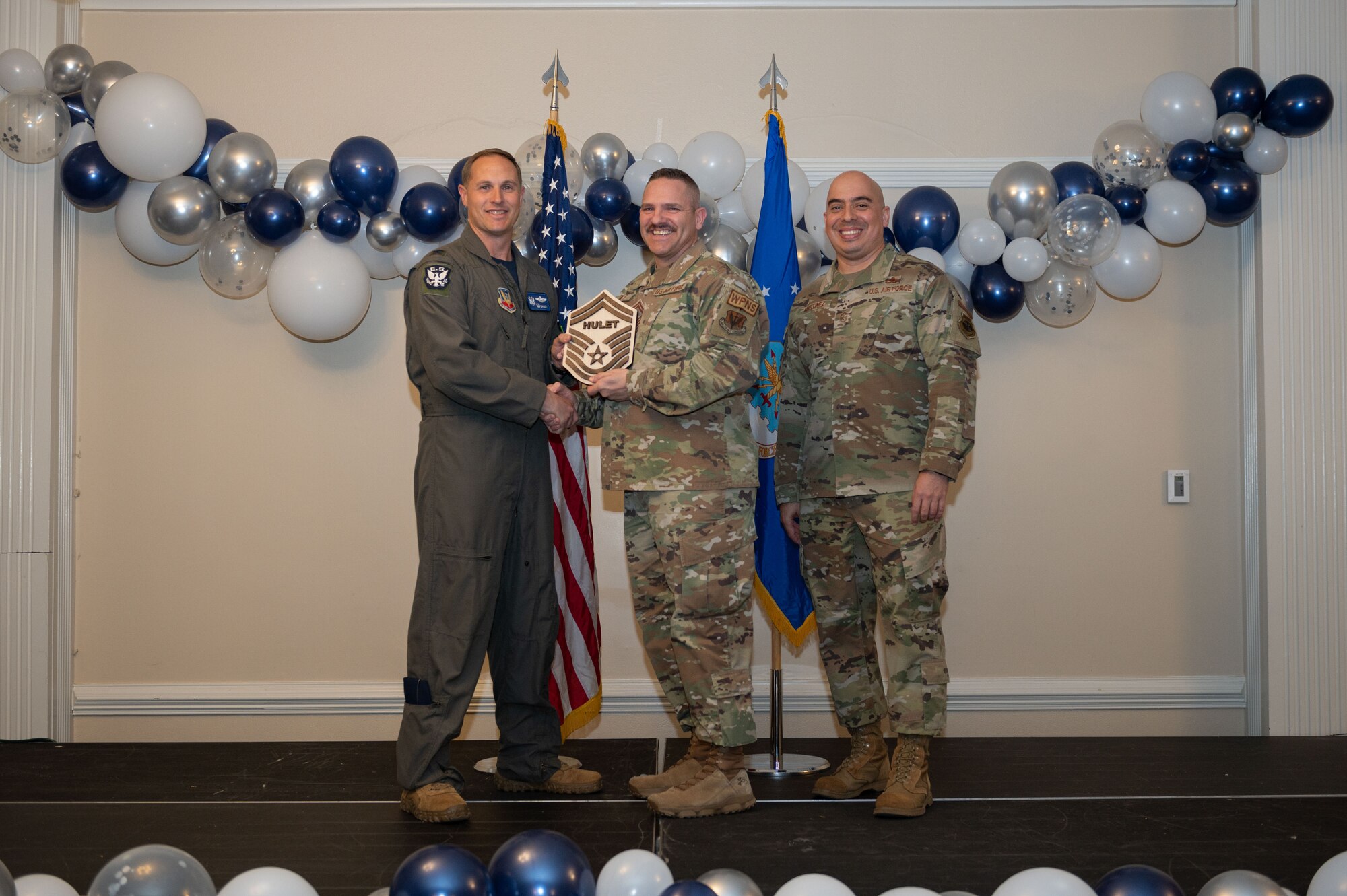 Col. Lucas Teel, 4th Fighter Wing commander, and Chief Master Sgt. Peter Martinez, 4th FW command chief, present a plaque to Senior Master Sgt. select Robb Hulet, 4th Maintenance Group lead standardization crew chief, during the senior master sergeant release ceremony at Seymour Johnson Air Force Base, North Carolina, March 17, 2023. Air Force officials selected 1,629 master sergeants for promotion to senior master sergeant, out of 16,031 eligible, for a selection rate of 10 percent this promotion cycle. (U.S. Air Force photo by Airman 1st Class Rebecca Sirimarco-Lang)
