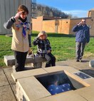 Eagle Scout Phillip Cavender, a member of Troop 74 in Tornado, West Virginia, built a large fire pit and benches on the grounds of the West Virginia Army National Guard St. Albans Armory for proper flag disposal. Cavender (far left) his grandmother and his father, retired Army Chief Warrant Officer 3 Chad Cavender salute the first flag disposed of during the initial ceremony on March 8, 2023. (U.S. Army photo by SGT Zoe Morris)