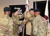 1st Lt. Andrew Whittenbarger, center left, passes the unit colors of the U.S. Army Medical Materiel Agency’s Headquarters and Headquarters Detachment to Sgt. 1st Class Tie Wu during a change of command ceremony March 17 at Fort Detrick, Maryland. Whittenbarger assumed command during the event, with Wu taking responsibility as detachment sergeant. Also pictured are USAMMA Commander Col. Gary Cooper, left, and outgoing detachment commander, Maj. Chris Wright.