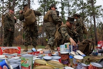 U.S. Marine Corps Col. Karin Fitzgerald, the commanding officer of 2nd Supply Battalion, 2nd Marine Logistics Group, leads a battalion hike on Camp Lejeune, North Carolina, March 10, 2023. Marines with 2nd Supply Battalion hiked a total of six miles carrying canned goods for donation to a local charity. (U.S. Marine Corps photo by Lance Cpl. Mary Kohlmann)