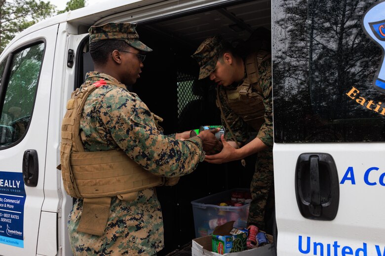 U.S. Marine Corps Col. Karin Fitzgerald, the commanding officer of 2nd Supply Battalion, 2nd Marine Logistics Group, leads a battalion hike on Camp Lejeune, North Carolina, March 10, 2023. Marines with 2nd Supply Battalion hiked a total of six miles carrying canned goods for donation to a local charity. (U.S. Marine Corps photo by Lance Cpl. Mary Kohlmann)