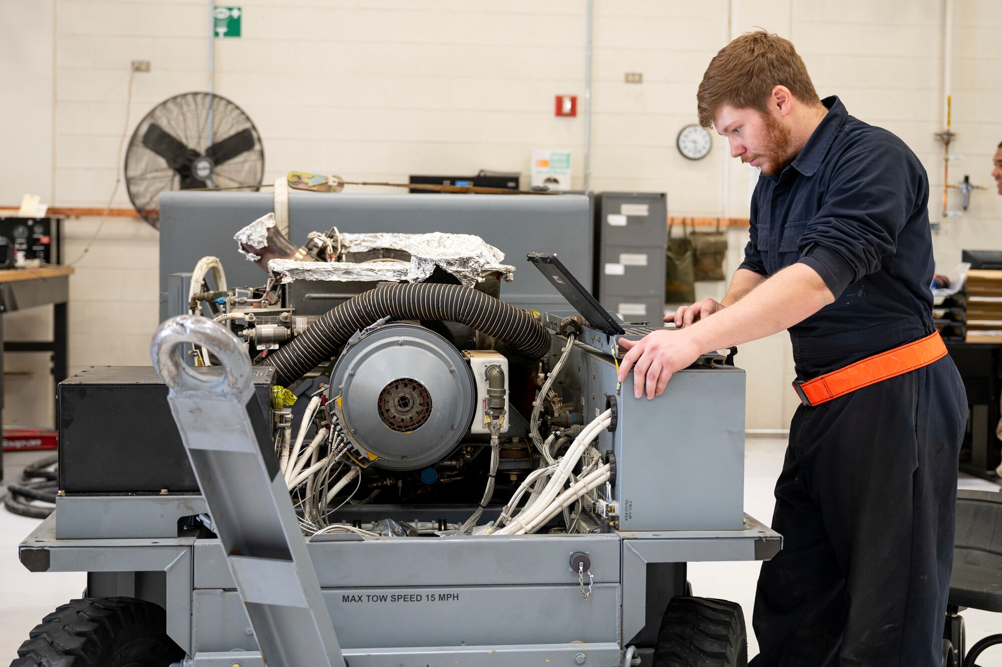 U.S. Air Force Senior Airman Caleb Kubesch, 49th Equipment Maintenance Squadron aerospace ground equipment journeyman, reviews technical orders for a dash 60 gas turbine engine at Holloman Air Force Base, New Mexico, March 21, 2023.