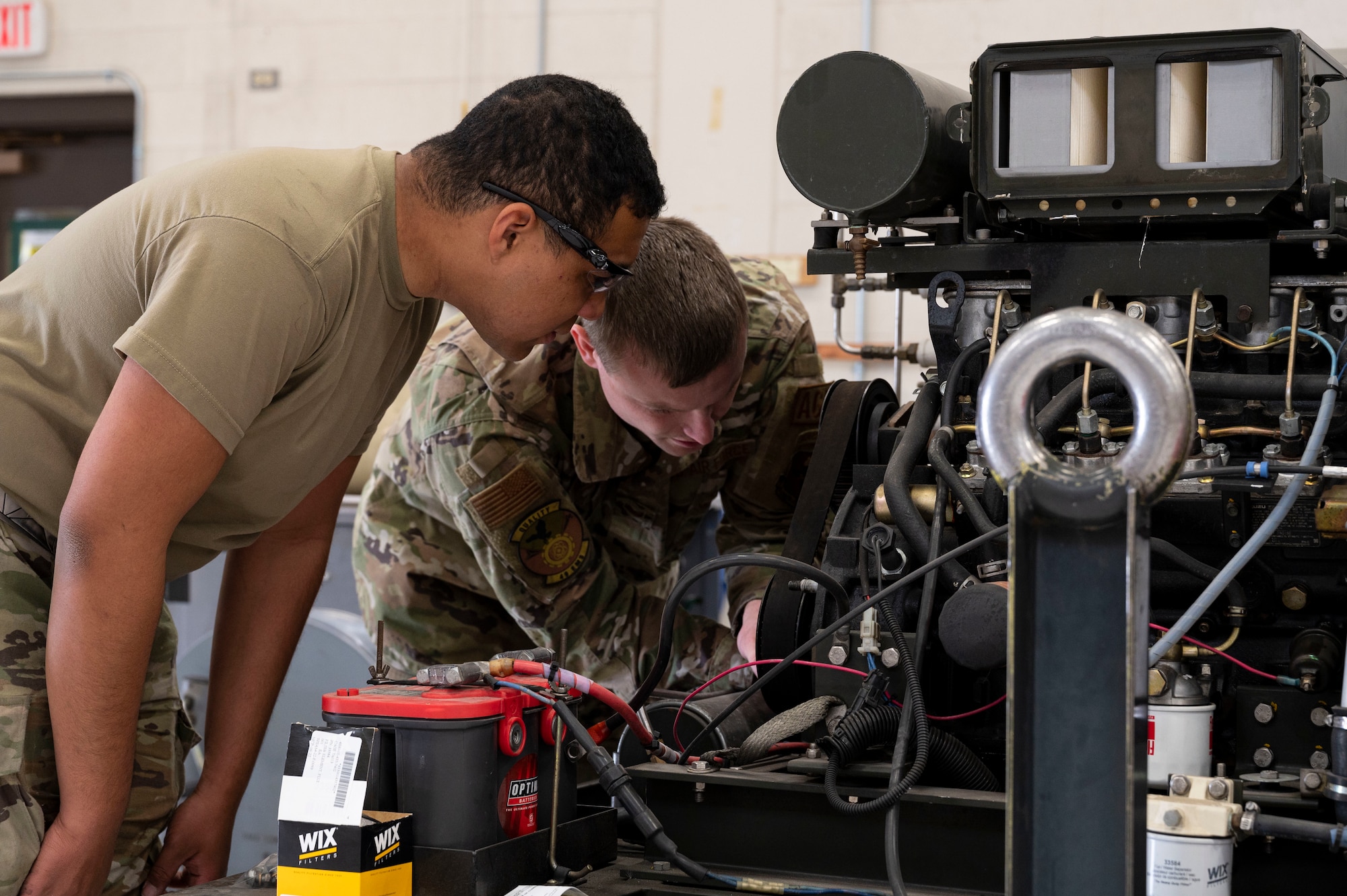 U.S. Air Force Senior Airman Kevon Hyde, 49th Equipment Maintenance Squadron aerospace ground equipment journeyman, left, and U.S. Air Force Staff Sgt. Edison Hargrove, 49th EMS AGE inspections lead, inspect a self-generating nitrogen servicing cart at Holloman Air Force Base, New Mexico, March 21, 2023.