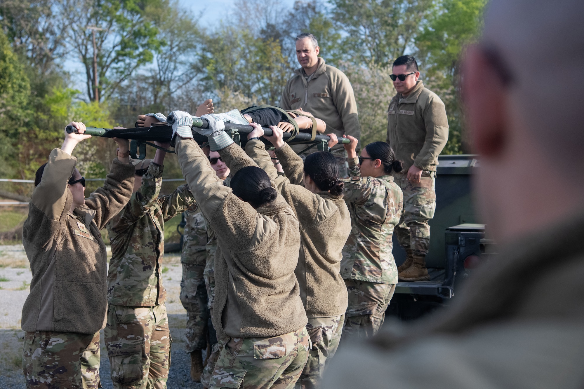 Airmen escort a dummy onto a Humvee at Maxwell Air Force Base, March 16, 2023. Airmen were able to use a Humvee and a helicopter for this training, provided by the Army National Guard.