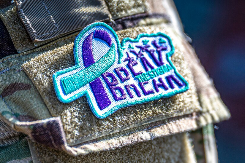 Close-up view of a patch on a camouflage sleeve.