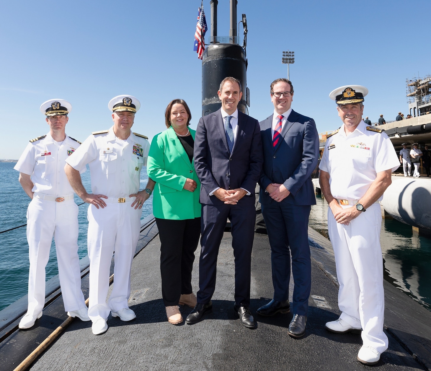 Australian Treasurer Jim Chalmers, center, poses for a photo onboard the Los Angeles-class fast-attack submarine USS Asheville (SSN 758) with WA Federal MPs Minister for Northern Australia and Resources Madeleine King, Minister for Defence Personnel and Veterans' Affairs Matt Keogh, Royal Australian Navy Rear Adm. Matt Buckley, Head of Capability, Nuclear Powered Submarine Task Force, right, Rear Adm. Rick Seif, commander, Submarine Group 7, second from left, and Cmdr. Tom Dixon, Asheville’s commanding officer following a tour, March 14. Asheville conducted multiple tours for distinguished visitors during a routine port visit to HMAS Stirling, Western Australia to enhance interoperability and communication, and strengthen relationships with the Royal Australian Navy.
