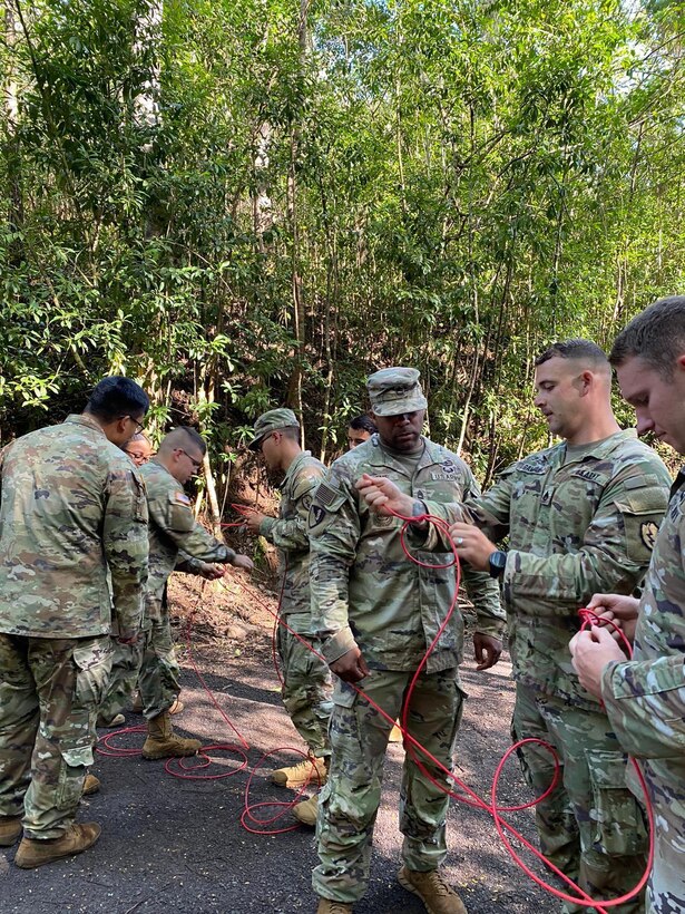 U.S. Army Soldiers assigned to 29th Brigade Engineer Battalion, 3rd Infantry Brigade Combat Team, 25th Infantry Division learn essential knots necessary for jungle traversal during their jungle train-up in May of 2022.