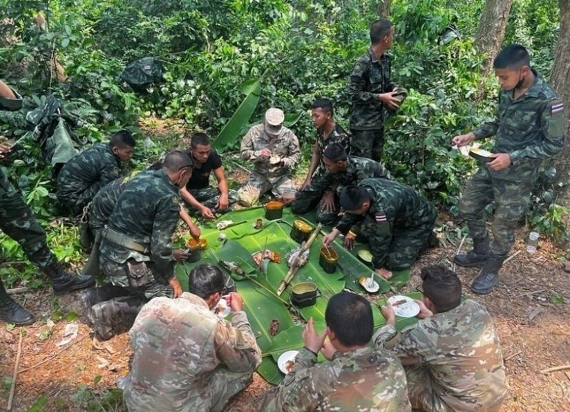 U.S. Army Soldiers assigned to 29th Brigade Engineer Battalion, 3rd Infantry Brigade Combat Team, 25th Infantry Division share a field meal with Thailand Soldiers during Hanuman Guardian March 2022. The training exercise allowed bravo company Soldiers to learn vital jungle survival skills from the Royal Thai Army. (U.S. Army photo by Capt. Michael Steele)