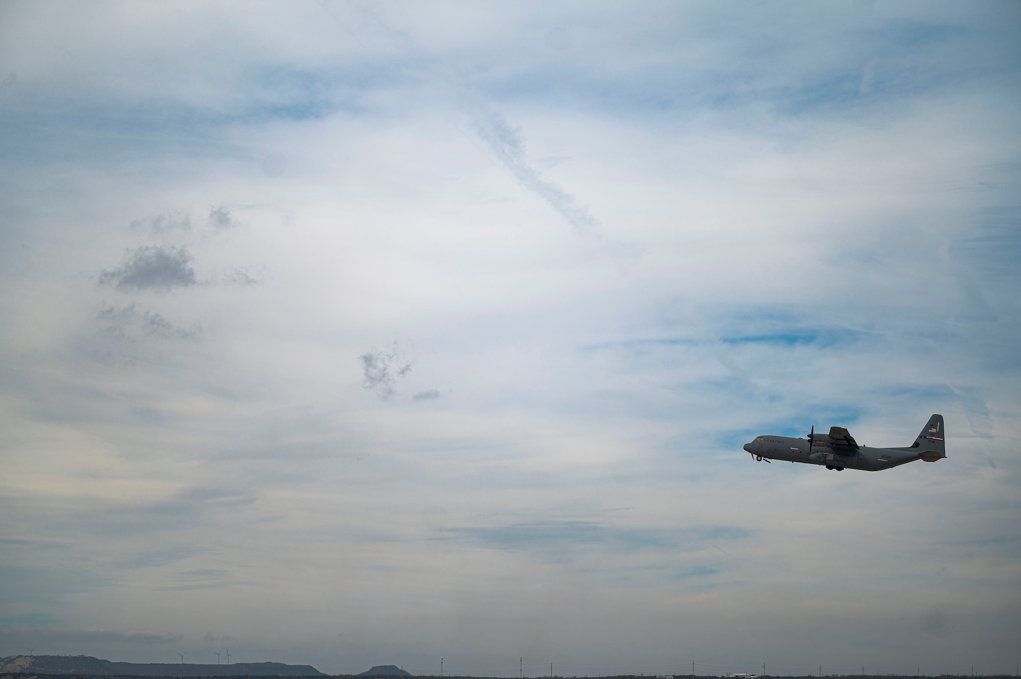 A C-130J Super Hercules takes off from Dyess Air Force Base, Texas, March 22, 2023. In preparation for possible inclement weather, Dyess Airmen rapidly prepared over a dozen aircraft to relocate, successfully demonstrating America’s Lift and Strike Base’s ability to achieve dynamic force employment while using agile combat employment. The relocation of aircraft from Dyess was used as an opportunity for units to exercise a “flush,” as the 317th did by giving aircrew simulated orders without a destination, which is a potential scenario they may face in a near-peer conflict, according to Col. Thomas Lankford, 317th Airlift Wing commander. “The crews showed up this morning with an overnight bag but had no idea what was going to happen next. They were handed a set of mission-type orders with the commander's intent to execute a rapid departure simulating an impending base attack,” said Lankford, “The crews were airborne, on average, within an hour from their arrival at the building. The 317th Maintenance teams did an absolutely incredible job making sure aircraft were ready to go. It is no easy task to show up thinking you’ll launch 3 airplanes and instead get 13 in the air. I brag that this team is the best in the business, and today they proved it.” (U.S. Air Force photo by Airman Emma Anderson)