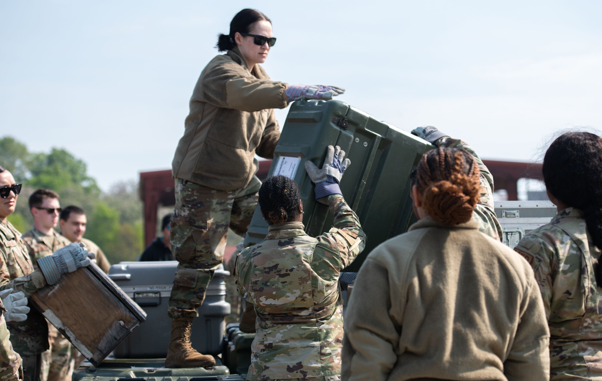 Airmen escort a person onto a helicopter at Maxwell Air Force Base, March 16, 2023. During the helicopter portion of the training, some of the Army’s non-commissioned officers taught Airmen how to escort a patient onto the helicopter while it was running.