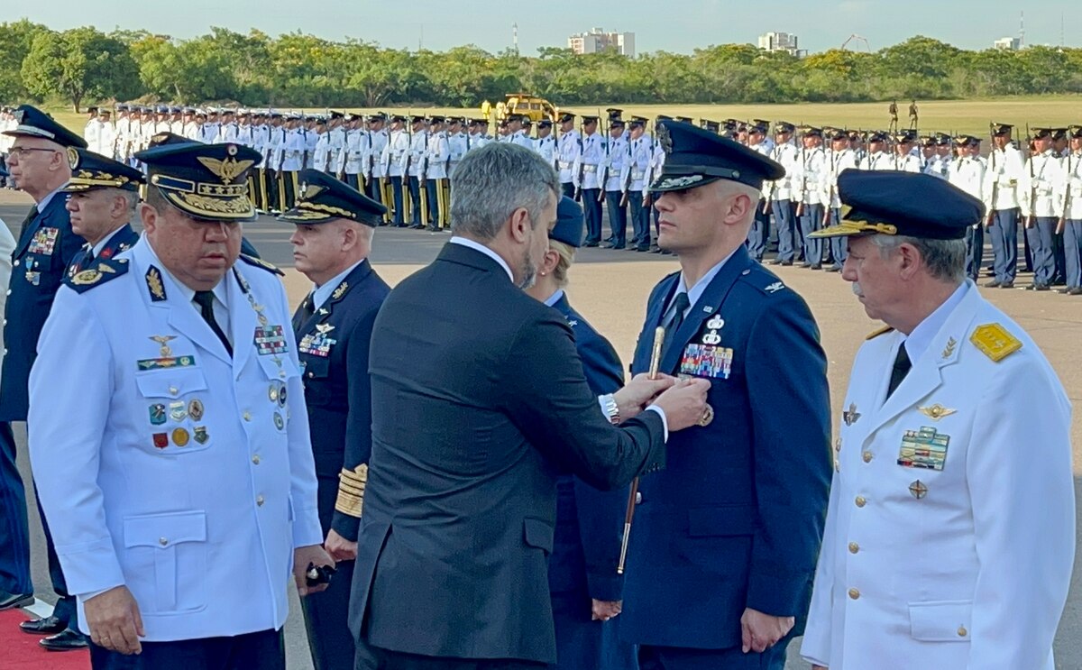 Mario Abdo Benitez, President of Paraguay, pins Col. José Jiménez, Jr., Commandant of the  Inter-American Air Forces Academy, with the Medal of Honor for the Centennial Commemoration of the Paraguayan Air Force in Asunción, Paraguay, Feb. 22, 2023. Benitez greeted senior members of visiting delegations and pinned each of them with the medal of honor to commemorate the anniversary. (Courtesy Photo)