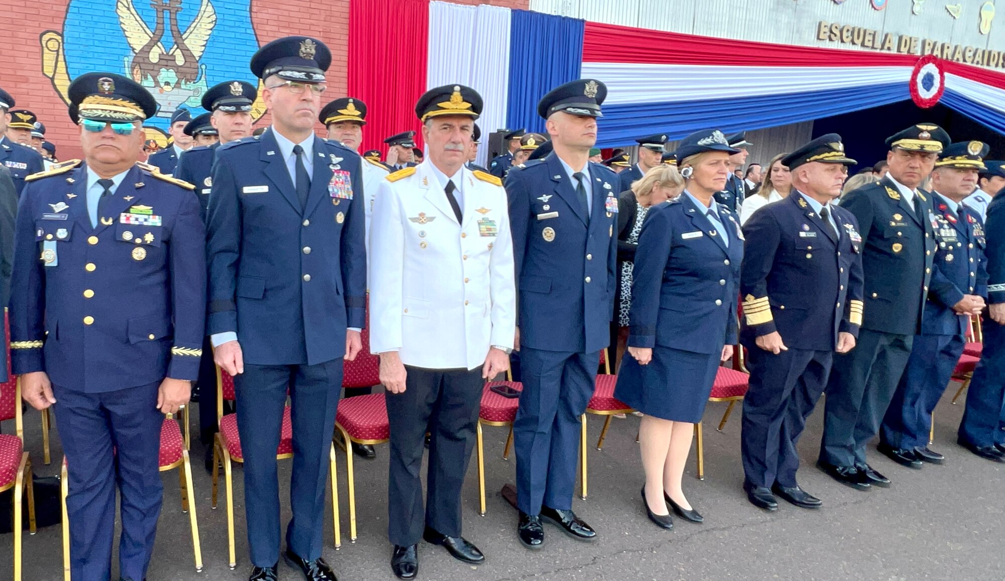 U.S. Air Force leaders Brig. Gen. Sean Choquette, 12th Air Force, Col. José Jiménez, Jr., Inter-American Air Forces Academy commandant, and Brig. Gen. Virginia Gaglio, Massachusetts Air National Guard, stand at attention beside other senior leaders at the Centennial Commemoration of the Paraguayan Air Force in Asunción, Paraguay, Feb. 22, 2023. Senior leaders from 10 countries attended the event to honor Paraguayan Air Force’s Centennial Anniversary. (Courtesy photo)