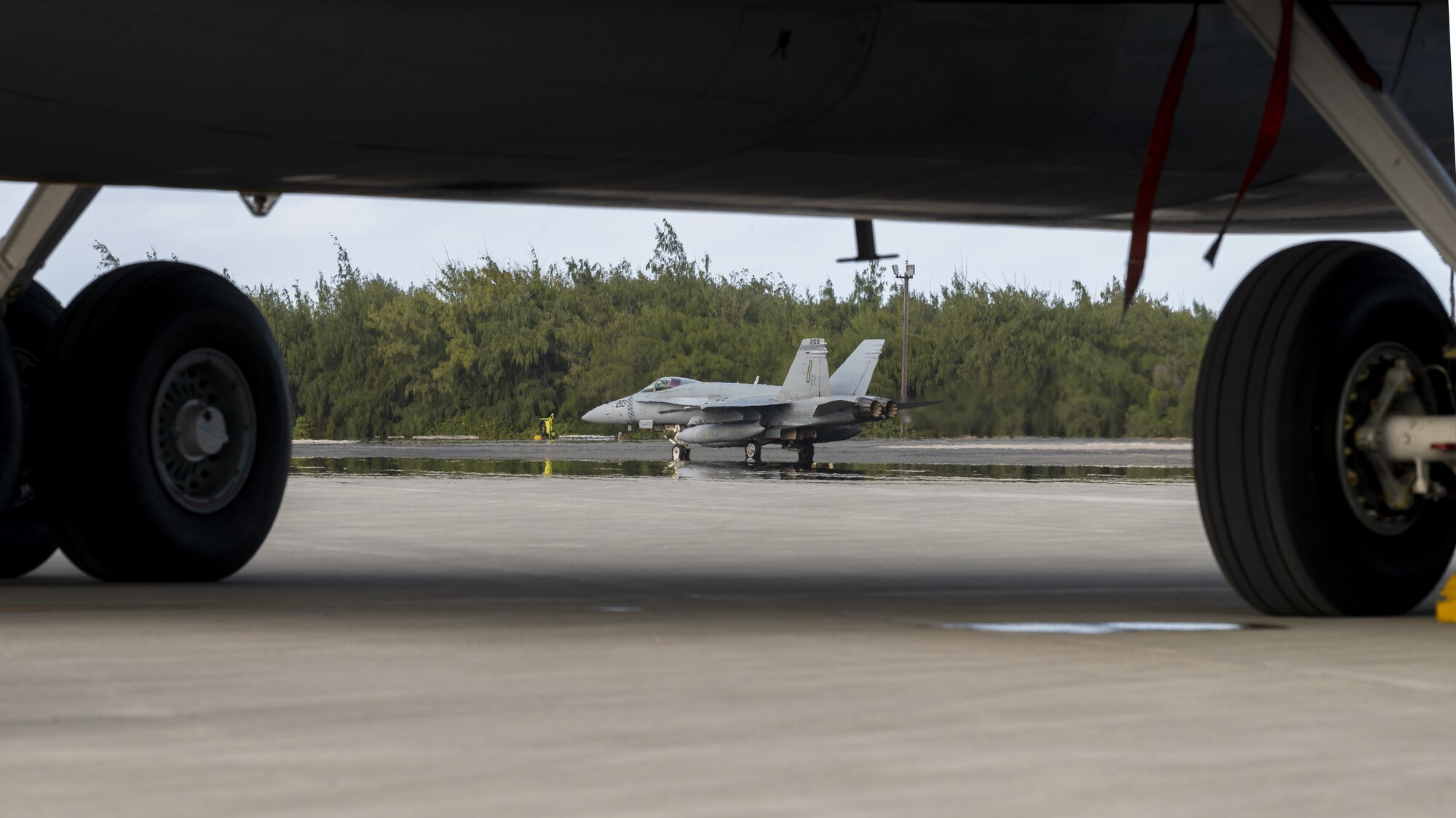 A U.S. Marine Corps F/A-18C Hornet taxis following an air refueling coronet mission at Wake Island, March 9, 2023. Aircrew from the 384th Air Refueling Squadron conducted an air refueling coronet with Marines from the Marine Fighter Attack Squadron 312, demonstrating the critical role mobility forces have in projecting the joint force anywhere, anytime. (U.S. Air Force photo by Staff Sgt. Lawrence Sena)