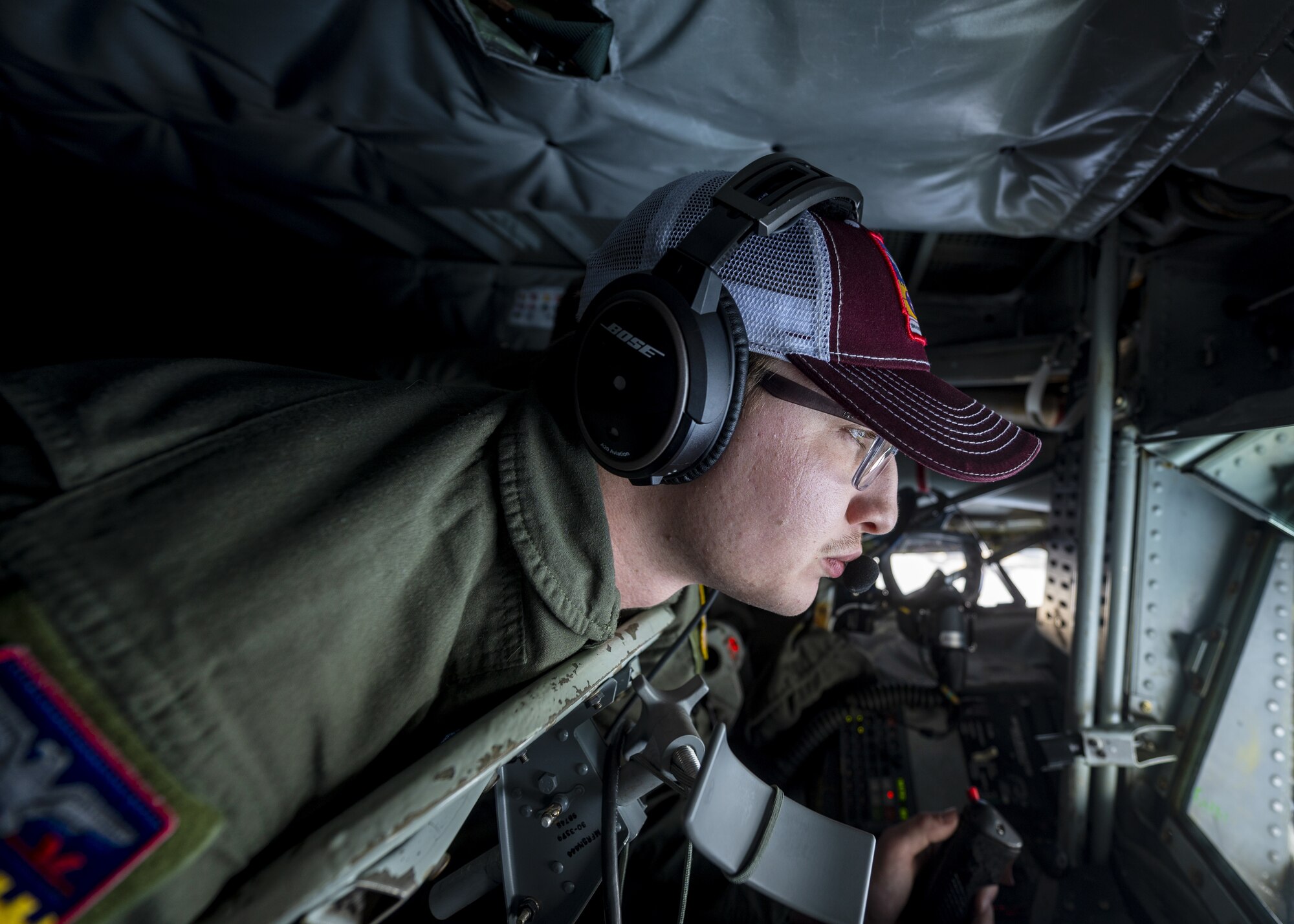 U.S. Air Force Airman 1st Class Aidan Ruehr, 384th Air Refueling Squadron boom operator, prepares to refuel U.S. Marine Corps F/A-18C Hornets during an air refueling coronet mission over the Pacific, March 9, 2023. Aircrew from the 384th Air Refueling Squadron conducted an air refueling coronet with Marines from the Marine Fighter Attack Squadron 312, demonstrating the critical role mobility forces have in projecting the joint force anywhere, anytime. (U.S. Air Force photo by Staff Sgt. Lawrence Sena)
