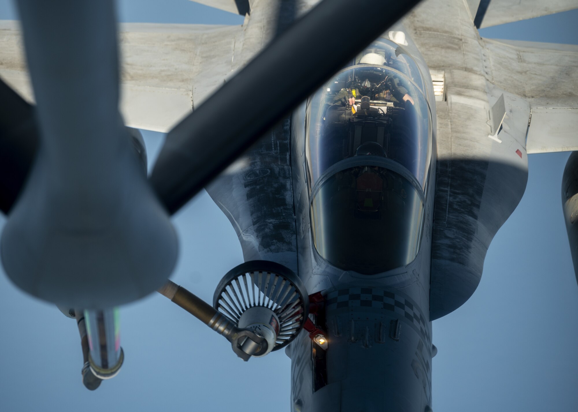 A U.S. Marine Corps F/A-18C Hornet is refueled by a U.S. Air Force KC-135 Stratotanker from Fairchild Air Force Base over the Pacific, March 9, 2023. Aircrew from the 384th Air Refueling Squadron conducted an air refueling coronet with Marines from the Marine Fighter Attack Squadron 312, demonstrating the critical role mobility forces have in projecting the joint force anywhere, anytime. (U.S. Air Force photo by Staff Sgt. Lawrence Sena)