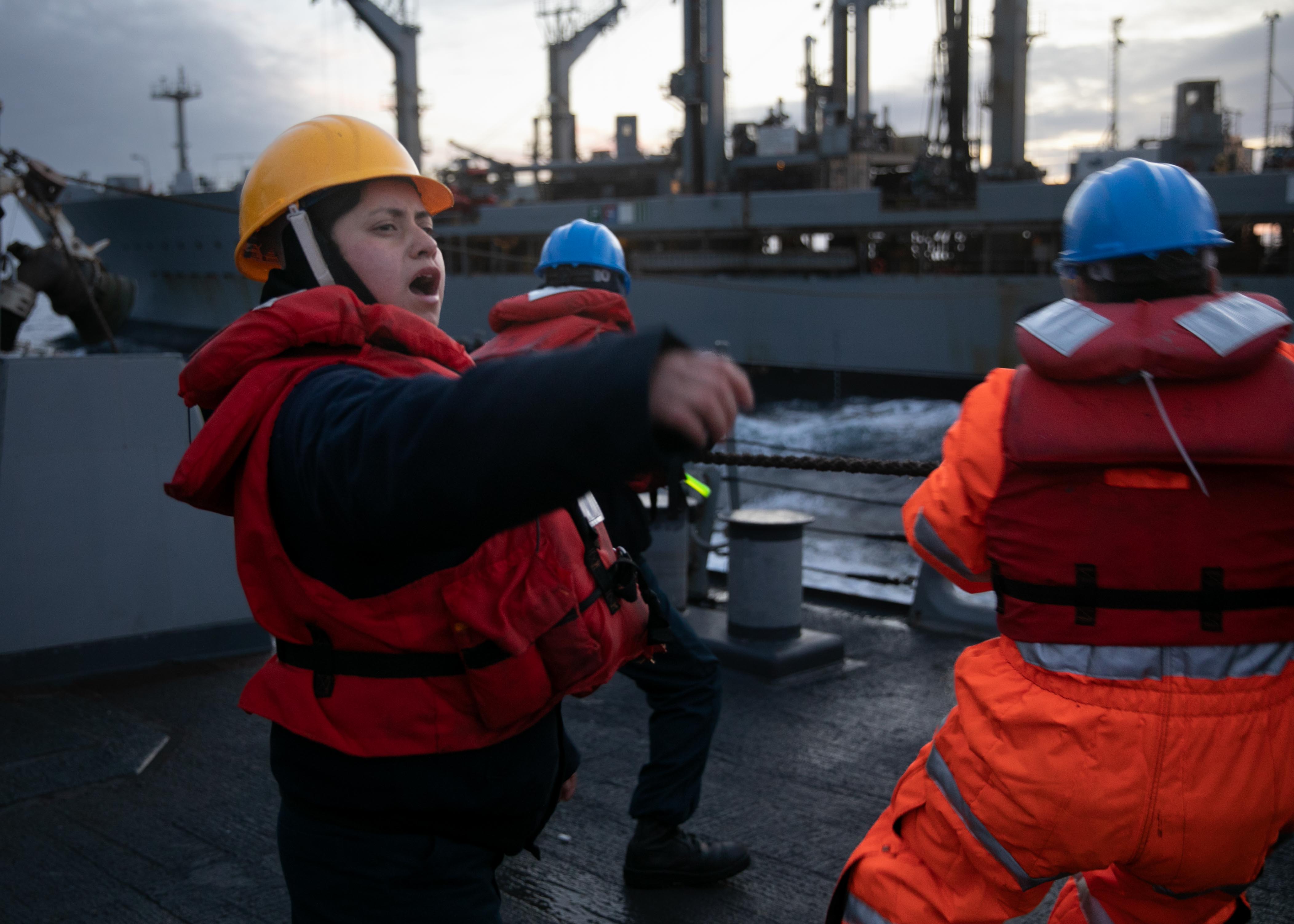 Boatswain’s Mate 2nd Class Jocelyn Salgado calls out commands to the line handlers aboard the Arleigh Burke-class guided-missile destroyer USS Arleigh Burke (DDG 51) during a refueling-at-sea with the Military Sealift Command fleet replenishment oiler USNS John Lenthall (T-A0-189), March 17, 2023.