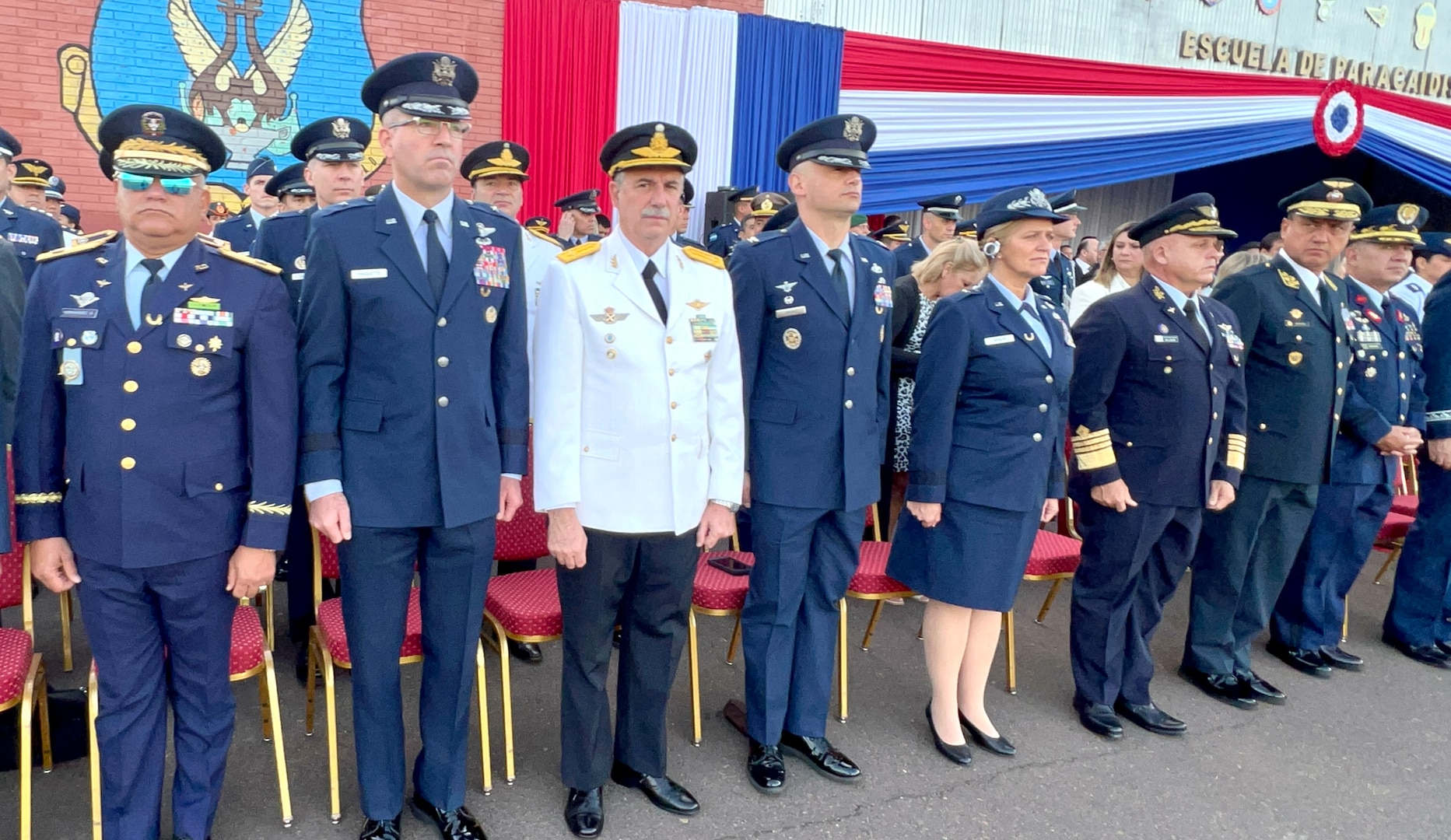 U.S. Air Force leaders Brig. Gen. Sean Choquette, 12th Air Force, Col. José Jiménez, Jr., Inter-American Air Forces Academy commandant, and Brig. Gen. Virginia Gaglio, Massachusetts Air National Guard, stand at attention beside other senior leaders at the Centennial Commemoration of the Paraguayan Air Force in Asunción, Paraguay, Feb. 22, 2023. Senior leaders from 10 countries attended the event to honor Paraguayan Air Force’s Centennial Anniversary. (Courtesy photo)