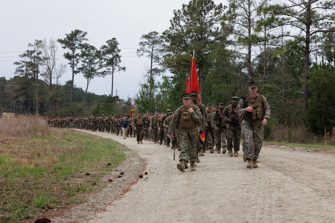 U.S. Marine Corps Col. Karin Fitzgerald, the commanding officer of 2nd Supply Battalion, 2nd Marine Logistics Group, leads a battalion hike on Camp Lejeune, North Carolina, March 10, 2023. Marines with 2nd Supply Battalion hiked a total of six miles carrying canned goods for donation to a local charity. (U.S. Marine Corps photo by Lance Cpl. Mary Kohlmann)