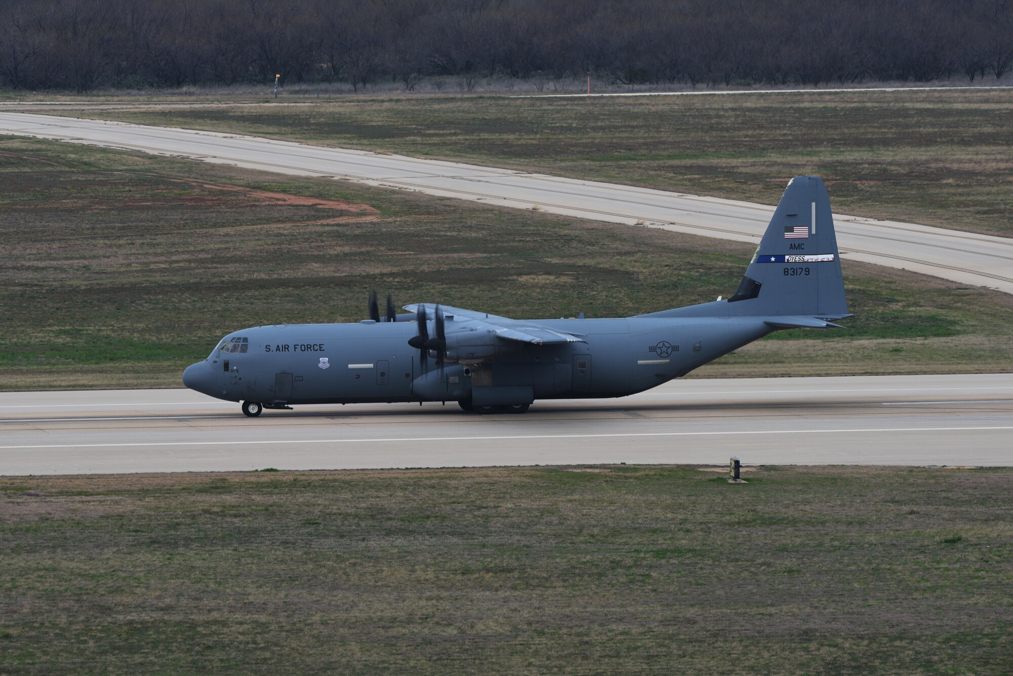 A C-130J Super Hercules taxis on the runway at Dyess Air Force Base, Texas, March 22, 2023. In preparation for possible inclement weather, Dyess Airmen rapidly prepared over a dozen aircraft to relocate, successfully demonstrating America’s Lift and Strike Base’s ability to achieve dynamic force employment while using agile combat employment. The B-1s were temporarily relocated to Holloman Air Force Base, New Mexico, while the C-130s flew to several airfields throughout the United States. (U.S. Air Force photo by Senior Airman Sophia Robello)