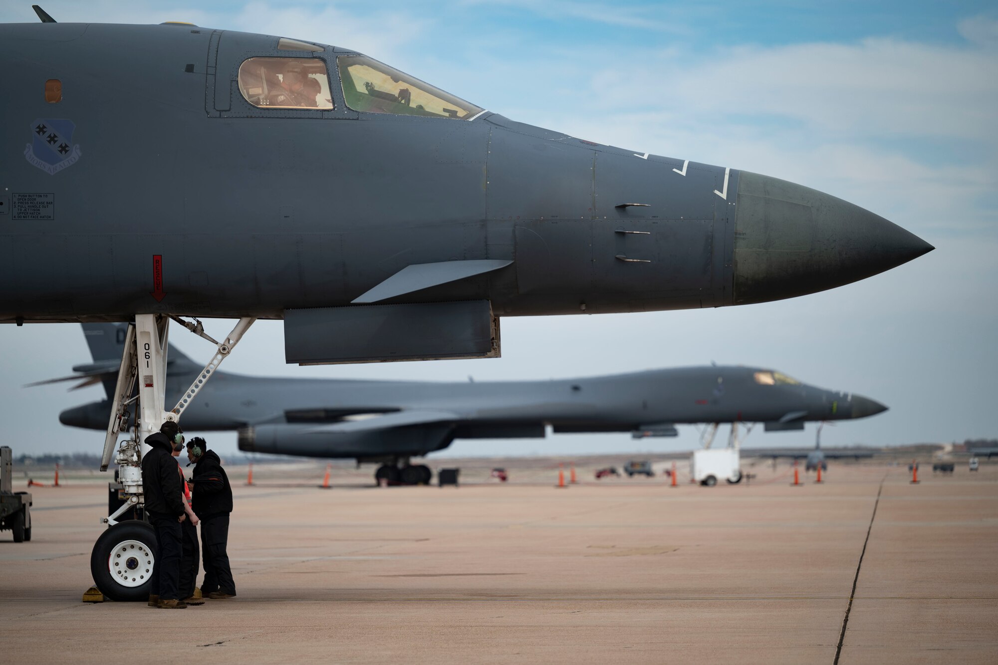 Aircrew and aircraft maintainers conduct pre-flight checks on a B-1B Lancer at Dyess Air Force Base, Texas, March 22, 2023. In preparation for possible inclement weather, Dyess Airmen rapidly prepared over a dozen aircraft to relocate, successfully demonstrating America’s Lift and Strike Base’s ability to achieve dynamic force employment while using agile combat employment. The B-1s were temporarily relocated to Holloman Air Force Base, New Mexico, while the C-130s flew to several airfields throughout the U.S. (U.S. Air Force photo by Airman Emma Anderson)
