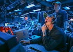 Sailors stand watch in CIC aboard USS Shiloh (CG 67).