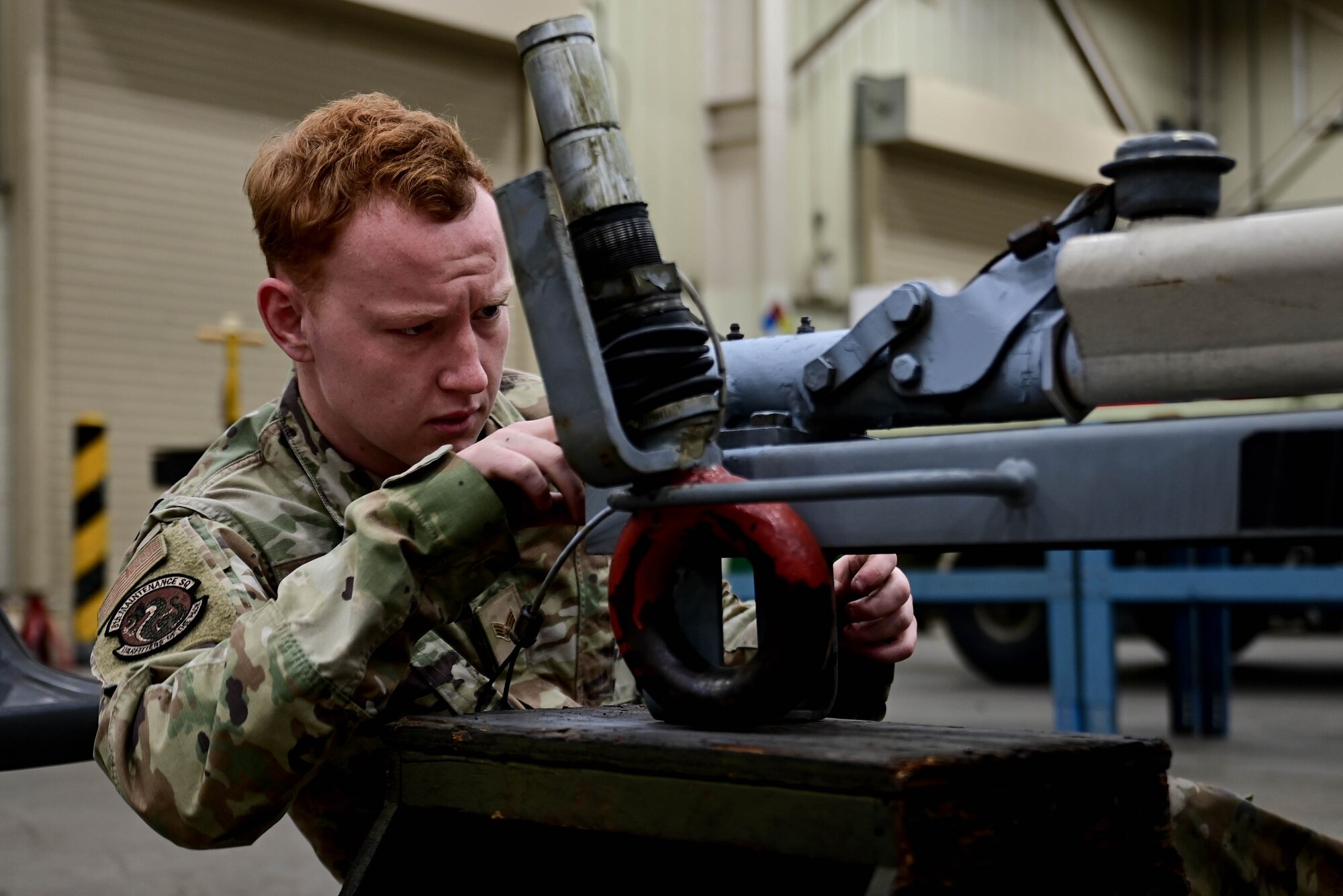 Senior Airman Raymond Taulbee, 8th Maintenance Squadron munitions systems equipment maintenance technician, inspects the tow hitch of a munitions trailer at Kunsan Air Base, Republic of Korea, Mar 15, 2023.