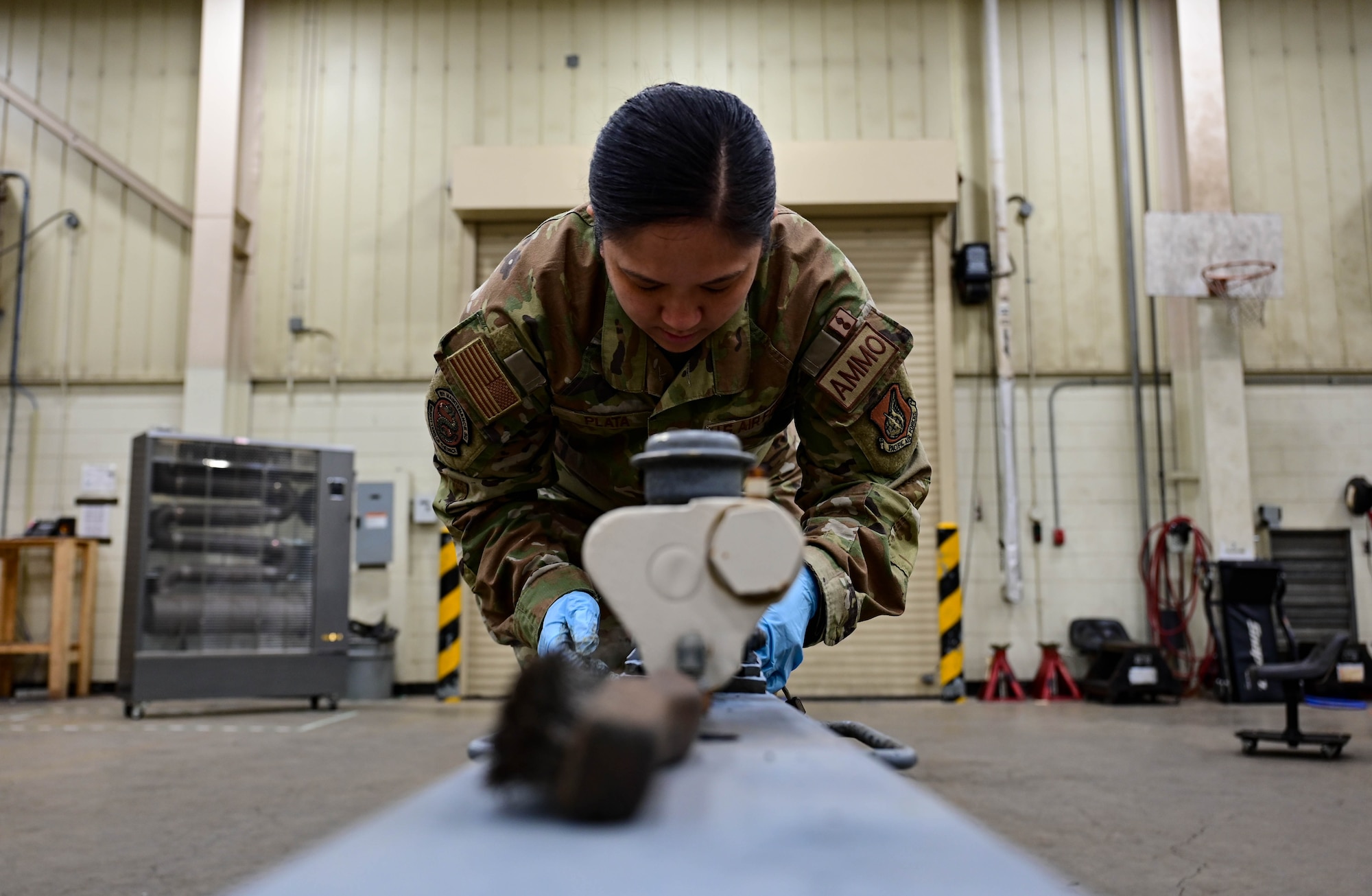 Staff Sgt. Kimberlyn Plata, 8th Maintenance Squadron munitions systems equipment maintenance crew chief, works on a munitions trailer tow hitch at Kunsan Air Base, Republic of Korea, Mar 15, 2023.