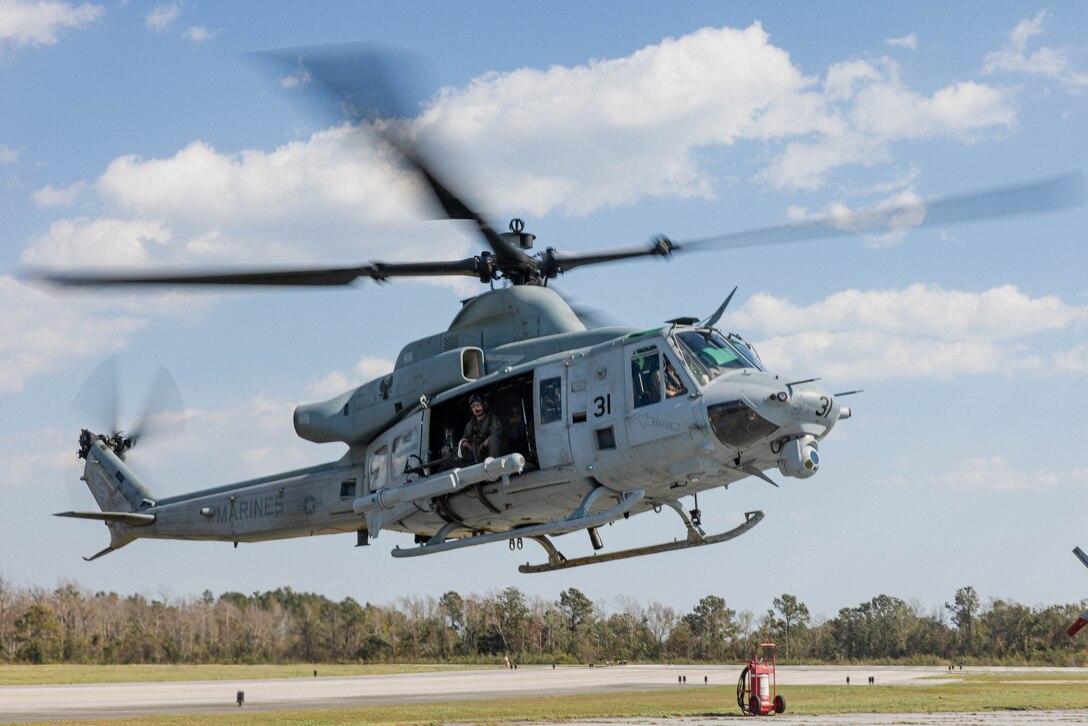A U.S. Marine Corps UH-1Y Venom, assigned to Marine Medium Tiltrotor Squadron (VMM) 162 Reinforced, 26th Marine Expeditionary Unit (MEU), takes off during MEU Exercise III at Marine Corps Auxiliary Landing Field Bogue, North Carolina, March 7, 2023. The Venom carried an Intrepid Tiger II, an organic, distributed, and networked airborne electronic warfare capability that are critical to operational mission success. (U.S. Marine Corps photo by Cpl. Kyle Jia)