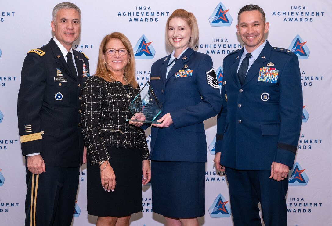 MSgt Scurry stands with GEN Nakasone, Tish Long, and Maj Gen
Thomas Hensley