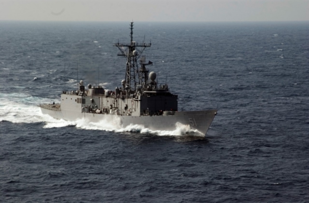 A ship moves through a sea.
