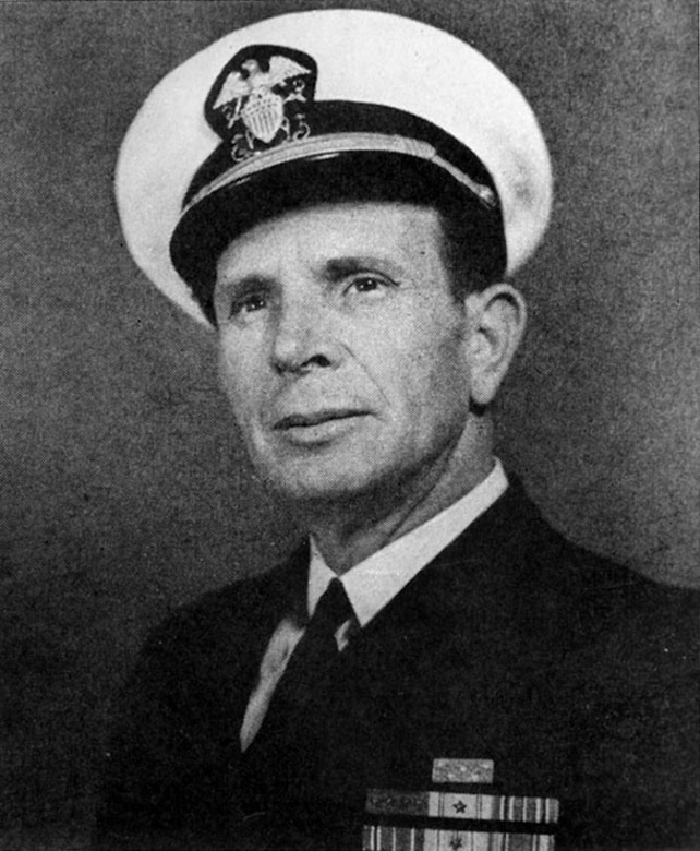 A man in dress uniform and cap poses for a photo.