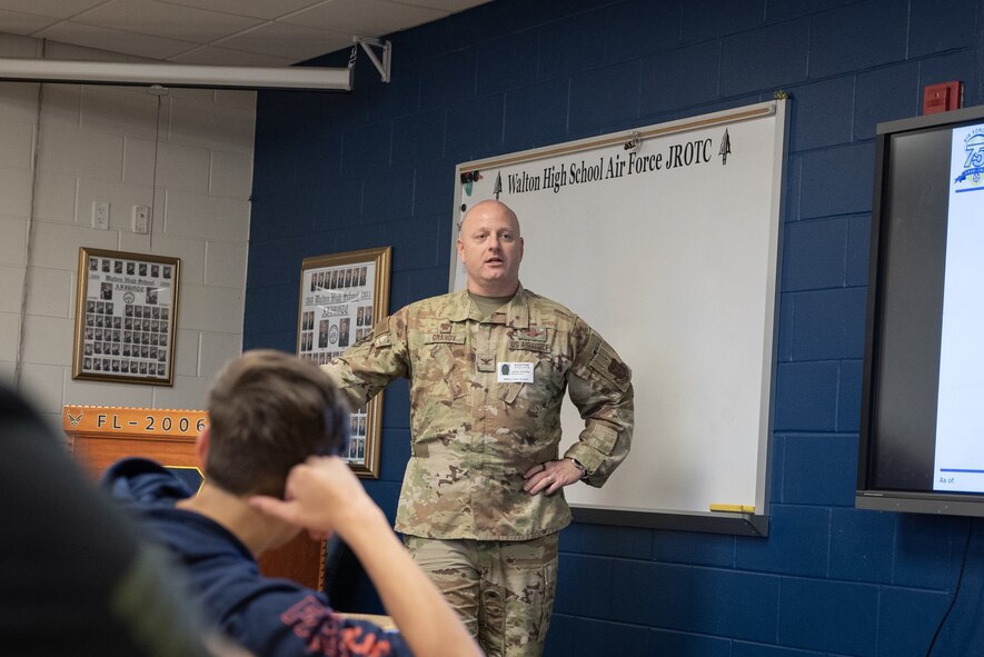A colonel speaks to cadets in a classroom