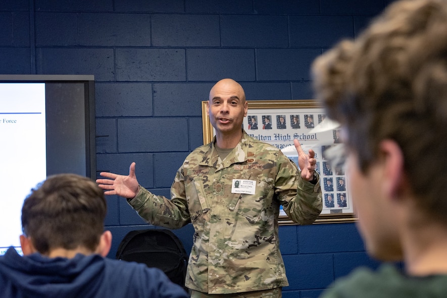 A male Air Force leader speaks to cadets in a classroom